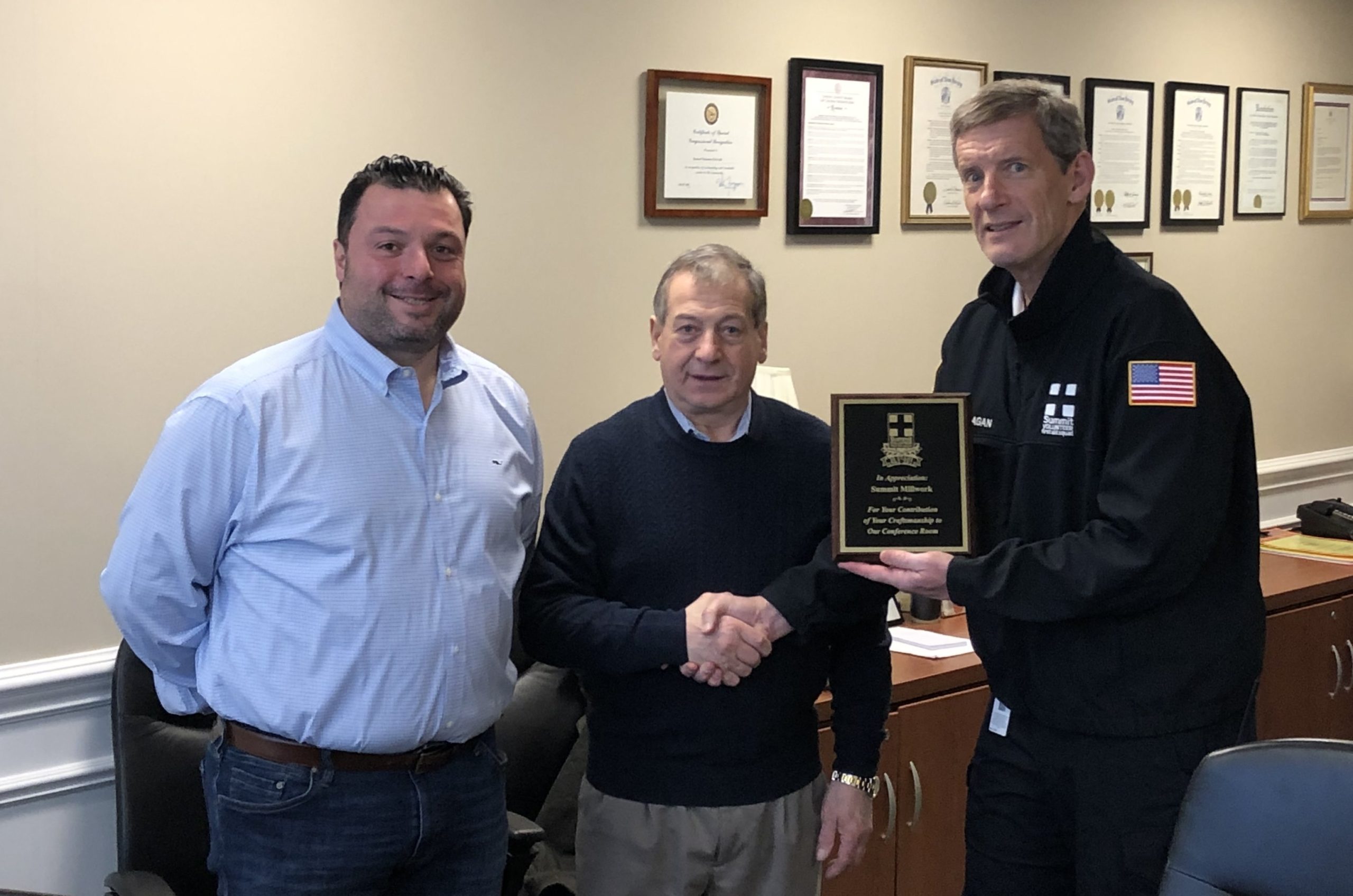 Nick Curiale and Aldo Curiale of Summit Millwork accept a plaque from First Aid Squad President Bob Flanagan (John Staunton photo).